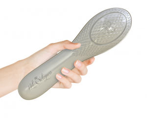 Picture of The Queen Bee - a hairbrush-shaped clitoral stimulation toy - being held in someone's hand