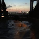 Girl on the net naked in a hot tub, pointing her arse at the camera. In the background you can see the London eye and other bits of the London skyline