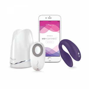 picture of a purple we-vibe sync next to an iPhone and charging station and we-vibe sync remote