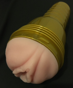 Fleshlight golden tube with a vagina in it