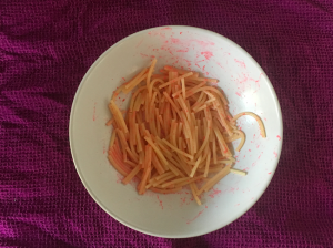 Bowl of short spaghetti dyed a lurid pink