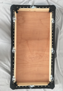 Underside view of the completed spanking bench top, now adorned with far too many shiny upholstery pins