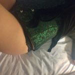 Glimpse of a woman's thigh and the bottom of her corset