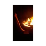 A hot image for a hot midnight fuck story - A naked leg and foot steps gently near a burning fire