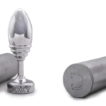 Image of two metal Doxy butt plugs - one ribbed and one smooth, with brushed aluminium cylindrical cases
