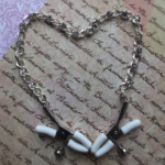 Image of nipple clamps with a chain arranged into the shape of a heart