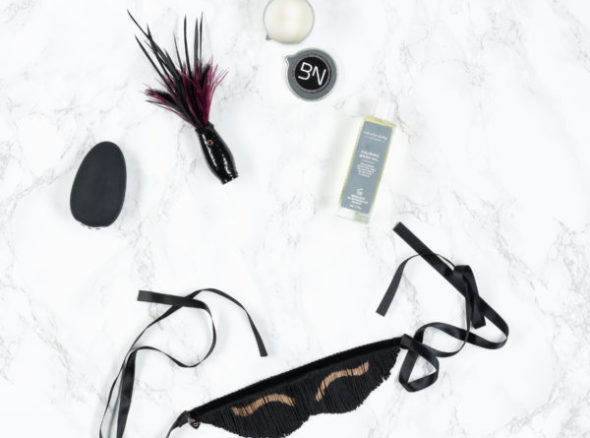Image of the gift set including fancy blindfold, tickler, egg-shaped vibrator and other goodies