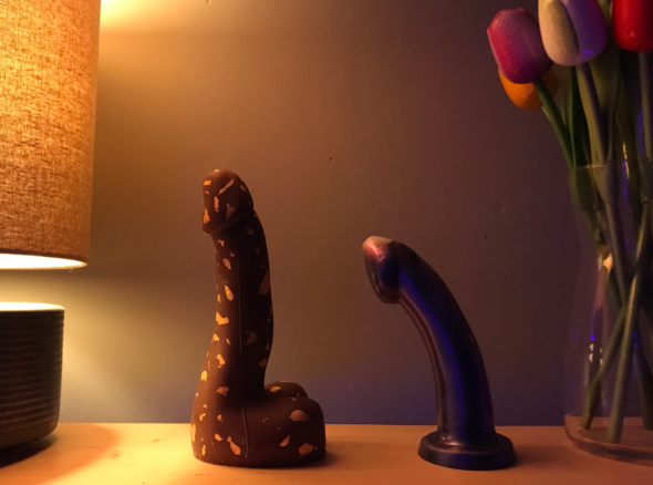 Chocolate dick on the left, purple silicone one on the right