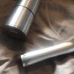 Image of brushed aluminium Doxy bullet next to brushed aluminium case