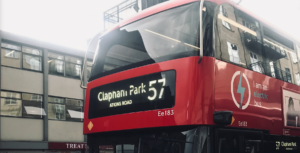 Close-cropped shot of the top front of a bus showing sign 57 and that it's heading towards Clapham Park