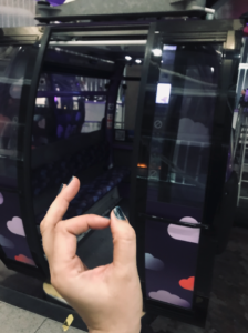 GOTN's fingers making the 'OK' sign in front of a purple Cable car pod