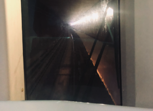 Very rubbish, blurry shot of the underground DLR tunnel - a dark passageway seen through the glass at the front of the train