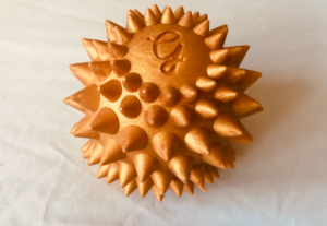 Golden silicone wand head attachment covered in short but harsh-looking spikes