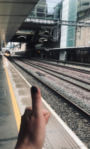 A high speed train with lights on pulling in to the platform at Stratford International, in the foreground GOTN's hand does a thumbs up