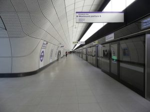 Shot of an empty platform in a very wide, bright, futuristic-looking underground station