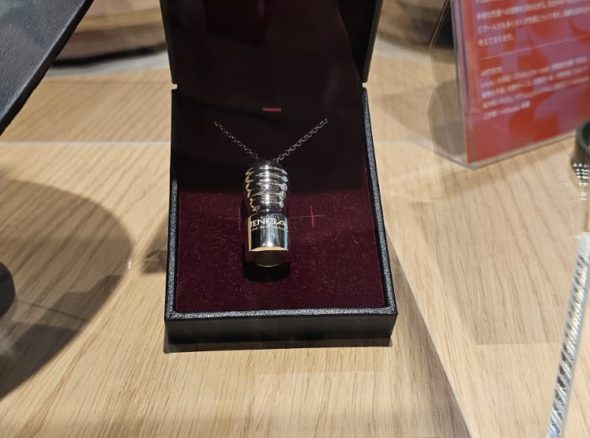 Silver necklace with a miniature silver Tenga wank sheath hanging form it. Price listed as 220,000 yen.