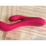 Pink rabbit-style vibrator laid out on pages of printed text which tell a filthy story about a free use secretary being used in turn by men at the team building meeting