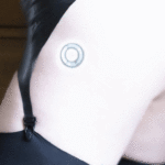 Close-up shot of a woman's bum and thighs in a thong, stockings and suspenders. Stamped on her thigh is a logo like you'd expect to see on a phone or computer